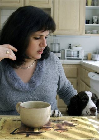 dogs and woman in kitchen - Woman and her dog having breakfast in the kitchen Stock Photo - Budget Royalty-Free & Subscription, Code: 400-03941419