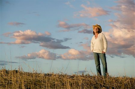 simsearch:400-04520905,k - Wide angle shot of a western woman against a cloudy sky at dusk. Photographie de stock - Aubaine LD & Abonnement, Code: 400-03941474