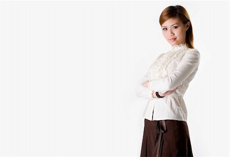 fresh face female in her thirties smiling - confident female business executive cross hand looking very approachable wearing a white blouse and dark brown skirt smiling Stock Photo - Budget Royalty-Free & Subscription, Code: 400-03941917