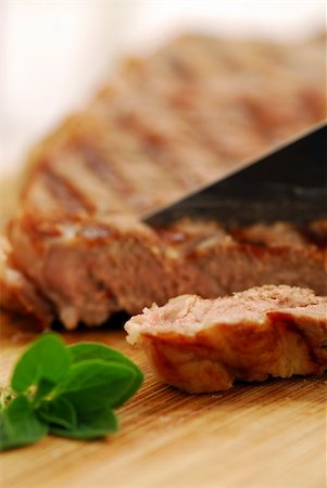 simsearch:400-04284643,k - Grilled steak being cut on a cutting board, closeup Stock Photo - Budget Royalty-Free & Subscription, Code: 400-03942178