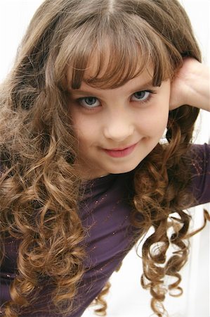 The portrait of the girl of the teenager with long hairs on light background. Fotografie stock - Microstock e Abbonamento, Codice: 400-03942272