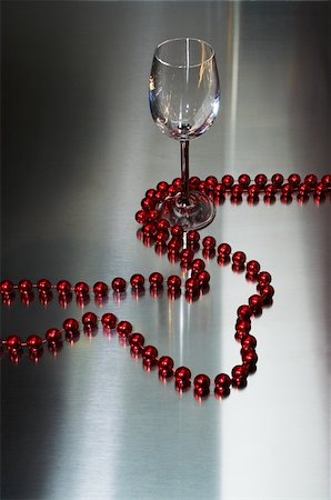 simsearch:614-00397185,k - Wine-glass and red beads on a metal background Stock Photo - Budget Royalty-Free & Subscription, Code: 400-03942692