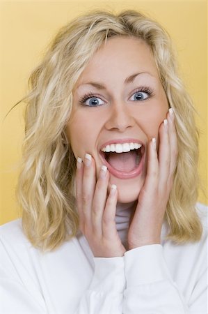 simsearch:400-03920671,k - Studio shot beautiful young blond woman looking happily surprised Stock Photo - Budget Royalty-Free & Subscription, Code: 400-03942796