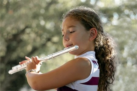 piccolo - Girl playing a flute Stock Photo - Budget Royalty-Free & Subscription, Code: 400-03942852