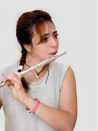 flutist (female) - Beautiful woman playing flute Photographie de stock - Aubaine LD & Abonnement, Code: 400-03942866