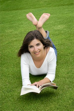 simsearch:400-04201795,k - Beautiful woman with a happy face and reading on the grass Fotografie stock - Microstock e Abbonamento, Codice: 400-03942929