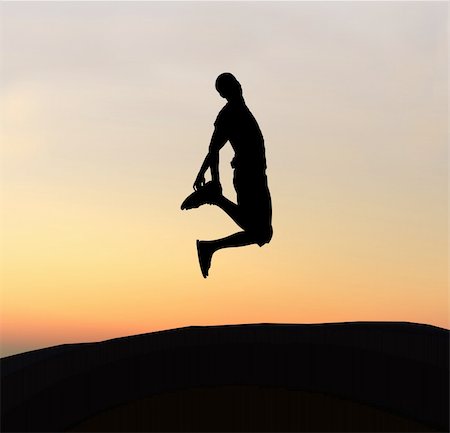 simsearch:400-03915748,k - Young boy silhouette jumping of joy - sunset background Fotografie stock - Microstock e Abbonamento, Codice: 400-03942991