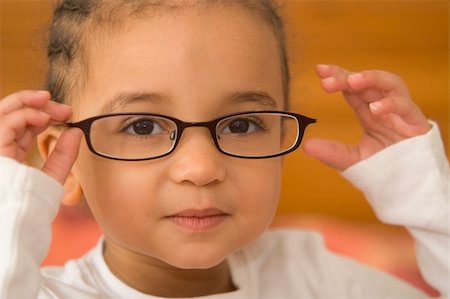 A beautiful young mixed race girl wearing slightly oversized glasses Stock Photo - Budget Royalty-Free & Subscription, Code: 400-03943212