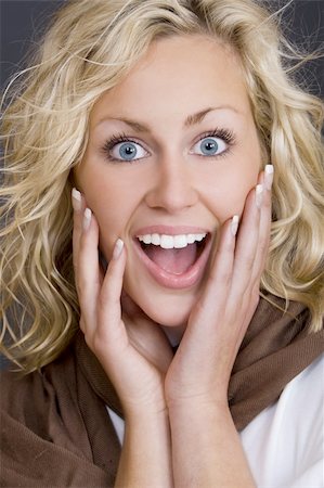 simsearch:400-03920671,k - Studio shot beautiful young blond woman wearing looking happily surprised Stock Photo - Budget Royalty-Free & Subscription, Code: 400-03943432