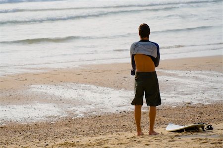 surfers men model - Young man getting dressed to go surfing. Horizontal shot. Stock Photo - Budget Royalty-Free & Subscription, Code: 400-03943862