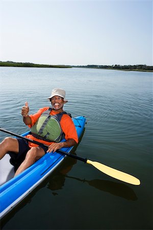 African American middle-aged man smiling and giving thumbs up gesure in kayak. Stock Photo - Budget Royalty-Free & Subscription, Code: 400-03943977