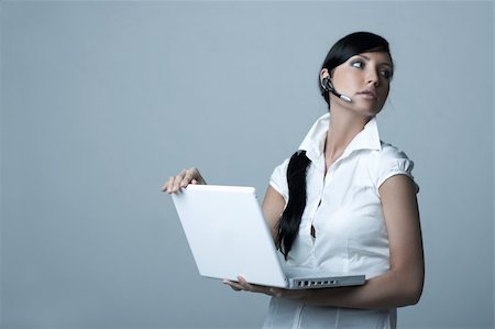 simsearch:400-03954172,k - Beautiful brunette business woman with wireless headset and laptop computer isolated on clear background Stock Photo - Budget Royalty-Free & Subscription, Code: 400-03954167