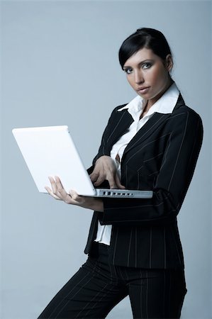 simsearch:400-03954172,k - Beautiful brunette business woman with laptop computer isolated on clear background Stock Photo - Budget Royalty-Free & Subscription, Code: 400-03954168