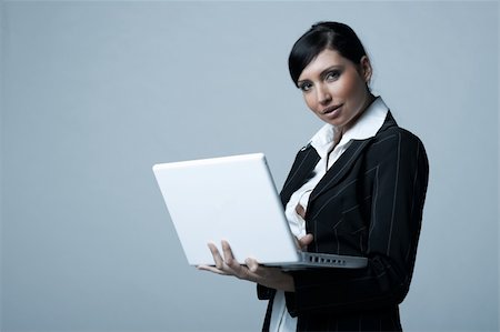 simsearch:400-03954172,k - Beautiful and sexy brunette business woman with laptop computer. She is isolated on clear background Stock Photo - Budget Royalty-Free & Subscription, Code: 400-03954170