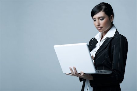 simsearch:400-03954172,k - Beautiful brunette business woman with laptop computer isolated on clear background Stock Photo - Budget Royalty-Free & Subscription, Code: 400-03954171