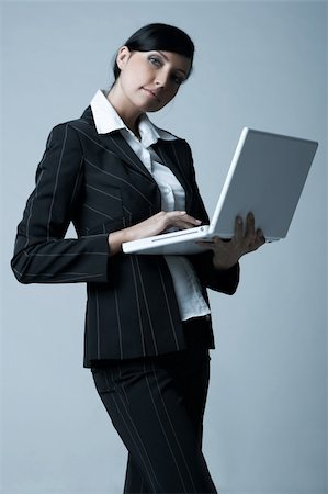 simsearch:400-03954172,k - Beautiful brunette business woman with laptop computer isolated on clear background Stock Photo - Budget Royalty-Free & Subscription, Code: 400-03954173