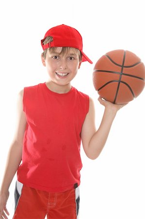 Hot, smiling child holding a basketball in one hand after the game Stock Photo - Budget Royalty-Free & Subscription, Code: 400-03954757