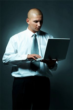 simsearch:400-03954954,k - A Young businessman with laptop computer Foto de stock - Super Valor sin royalties y Suscripción, Código: 400-03954971