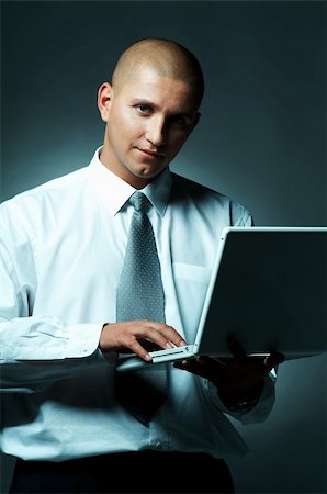 simsearch:400-03954954,k - A Young businessman with laptop computer Foto de stock - Super Valor sin royalties y Suscripción, Código: 400-03954972