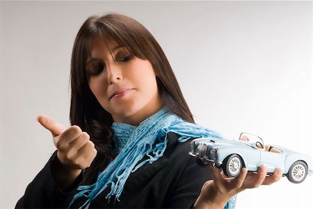 a young and elegant woman looking with interest at a model of a lancia car Stock Photo - Budget Royalty-Free & Subscription, Code: 400-03955266