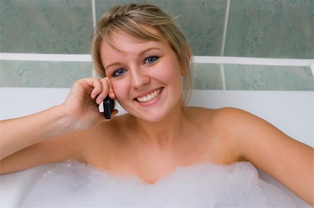A pretty young woman relaxing in a bubble bath and chatting on her mobile phone Stock Photo - Budget Royalty-Free & Subscription, Code: 400-03955370