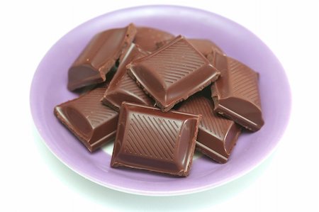 It is a lot of segments of chocolate lay on a plate Stockbilder - Microstock & Abonnement, Bildnummer: 400-03956100