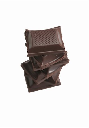 It is a lot of segments of chocolate on a white background Photographie de stock - Aubaine LD & Abonnement, Code: 400-03956102