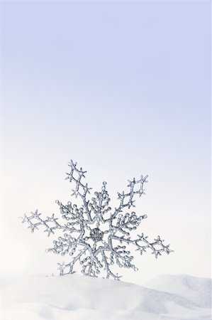 Sparkling snowflake in the snow with white background Stock Photo - Budget Royalty-Free & Subscription, Code: 400-03956752
