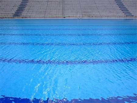 simsearch:400-07622541,k - Trembling surface of an Olympic size swimming pool in empty sport arena Stock Photo - Budget Royalty-Free & Subscription, Code: 400-03957042