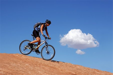 Woman mountain biking on slick rock in Moab, Utah Photographie de stock - Aubaine LD & Abonnement, Code: 400-03957567