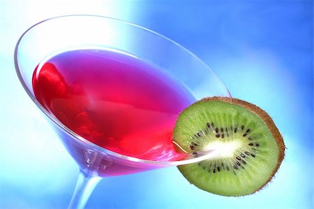 simsearch:6102-03828319,k - Red cocktail with kiwi garnish and blue light background Stock Photo - Budget Royalty-Free & Subscription, Code: 400-03957582