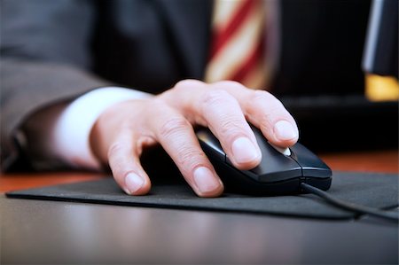 people at work: close-up of a businessman's hand using a mouse Stock Photo - Budget Royalty-Free & Subscription, Code: 400-03959856