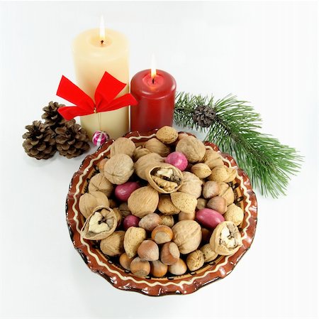 Symbols of Christmas and New Year on White background. Christmas decoration. The good meat of the walnut broken in first minutes of the New year shows good luck during entire year. Stock Photo - Budget Royalty-Free & Subscription, Code: 400-03950096