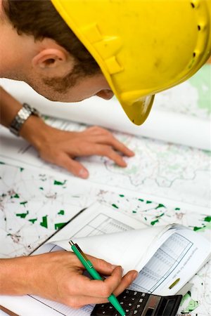 construction worker checking documents and maps Stock Photo - Budget Royalty-Free & Subscription, Code: 400-03950143