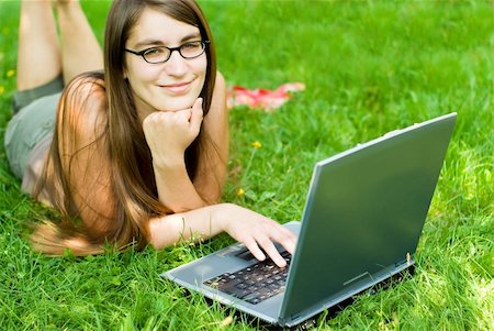 shopping laptop eyeglasses - portrait of young woman surfing the internet outdoors on her notebook Stock Photo - Budget Royalty-Free & Subscription, Code: 400-03950169