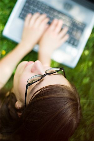 shopping laptop eyeglasses - portrait of young woman surfing the internet outdoors on her notebook Stock Photo - Budget Royalty-Free & Subscription, Code: 400-03950171
