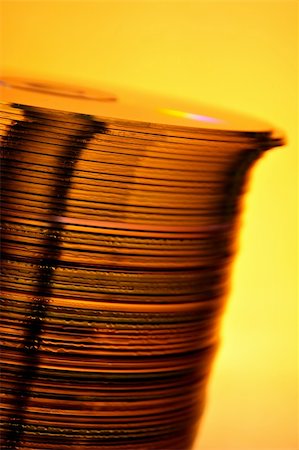 Stack of Cds on yellow background Stock Photo - Budget Royalty-Free & Subscription, Code: 400-03950270