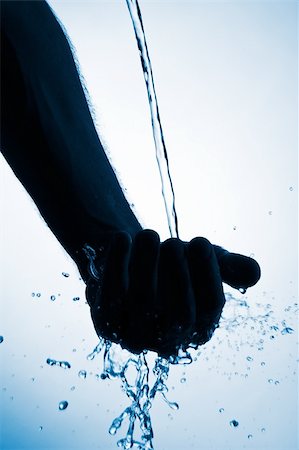 streaming water close up - Water pouring into hand and splashing Stock Photo - Budget Royalty-Free & Subscription, Code: 400-03950311