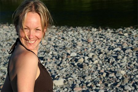 A sexy girl smiles against a smooth rock background. Stock Photo - Budget Royalty-Free & Subscription, Code: 400-03950476