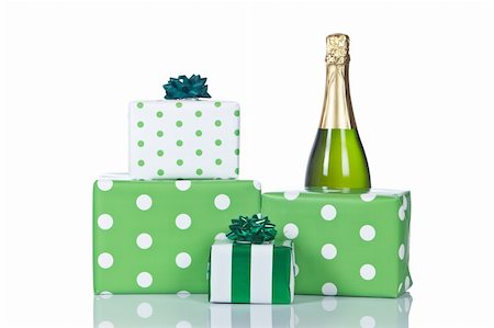 simsearch:614-06813440,k - Assortment of gifts and champagne bottle, reflected on white background. Shallow DOF Stockbilder - Microstock & Abonnement, Bildnummer: 400-03950894