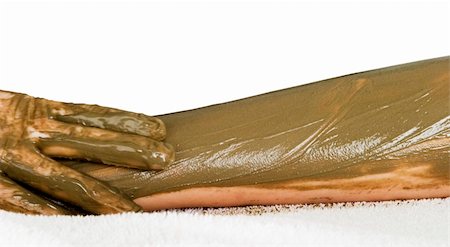 simsearch:400-03951218,k - A detail image of a sea mud full body wrap at a luxury spa being applied to the arm, with motion blur on the hand applying the mud pack. Foto de stock - Royalty-Free Super Valor e Assinatura, Número: 400-03951225