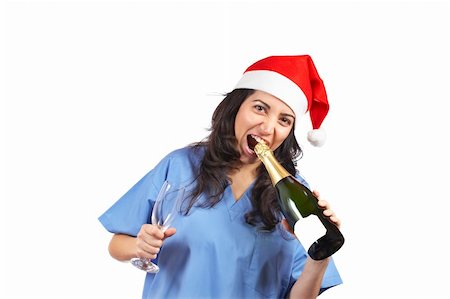 Friendly female doctor with christmas hat, glass and champagne bottle Stock Photo - Budget Royalty-Free & Subscription, Code: 400-03951283