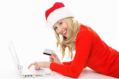 Shopping online is easy, convenient and secure.  Smiling female using a laptop and holding a credit card or other card to buy Christmas gifts, pay bills or  banking.  Data on back of  card has been replaced. Stock Photo - Budget Royalty-Free & Subscription, Code: 400-03952135