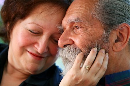 simsearch:400-05711437,k - Affectionate old couple with the wife holding on lovingly to the husband's face. Focus on the husband's eyes. Concept: Elderly love. Foto de stock - Super Valor sin royalties y Suscripción, Código: 400-03953174