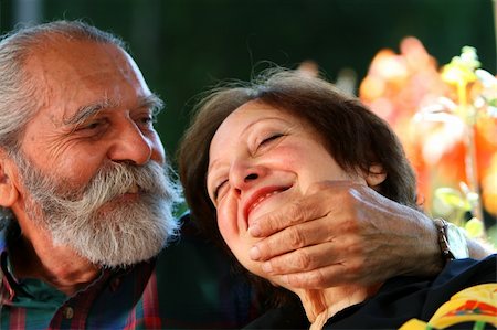 simsearch:400-04326057,k - Affectionate old couple with the wife holding on lovingly to the husband's face. Focus on the husband's eyes. Concept: Elderly love. Foto de stock - Super Valor sin royalties y Suscripción, Código: 400-03953175