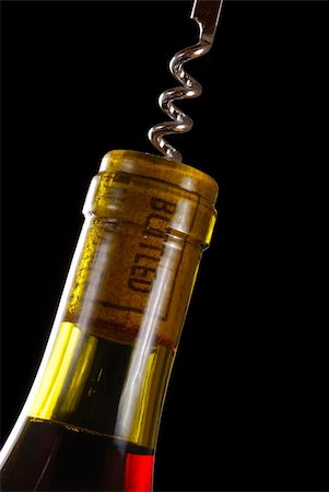 simsearch:659-06671105,k - Opening a wine bottle with corkscrew, isolated on black Stockbilder - Microstock & Abonnement, Bildnummer: 400-03953336