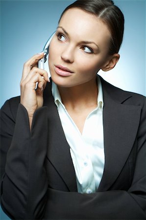simsearch:400-03954172,k - Beautiful and sexy brunette business woman isolated on clear background is using mobile phone. Stock Photo - Budget Royalty-Free & Subscription, Code: 400-03953387