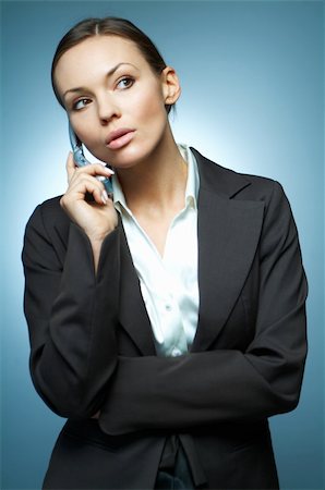 simsearch:400-03954172,k - Beautiful and sexy brunette business woman isolated on clear background is using mobile phone. Stock Photo - Budget Royalty-Free & Subscription, Code: 400-03953388