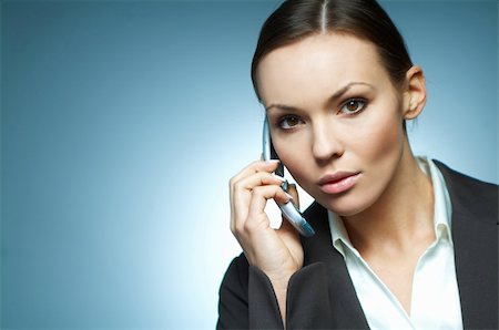 simsearch:400-03954172,k - Beautiful and sexy brunette business woman isolated on clear background is using mobile phone. Stock Photo - Budget Royalty-Free & Subscription, Code: 400-03953389