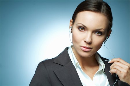 simsearch:400-03954172,k - Beautiful and sexy brunette business woman isolated on clear background with headphones is listen to the music. Stock Photo - Budget Royalty-Free & Subscription, Code: 400-03953396